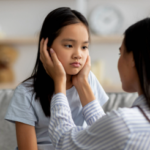 A sick child is comforted by a parent.